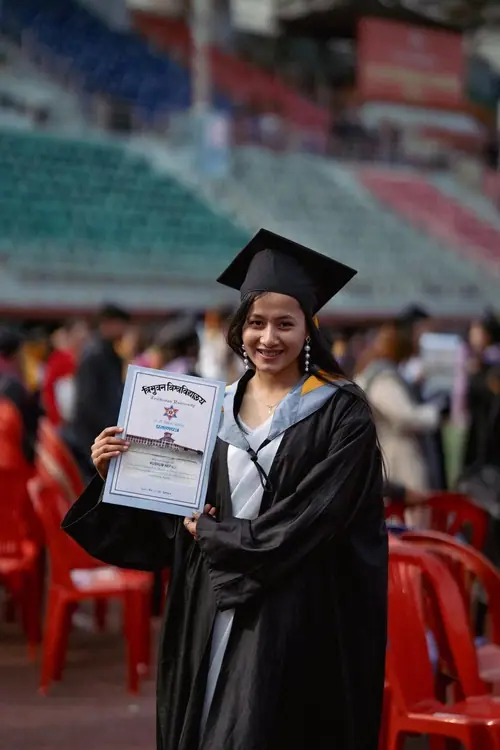 Kushum smiling on graduation day